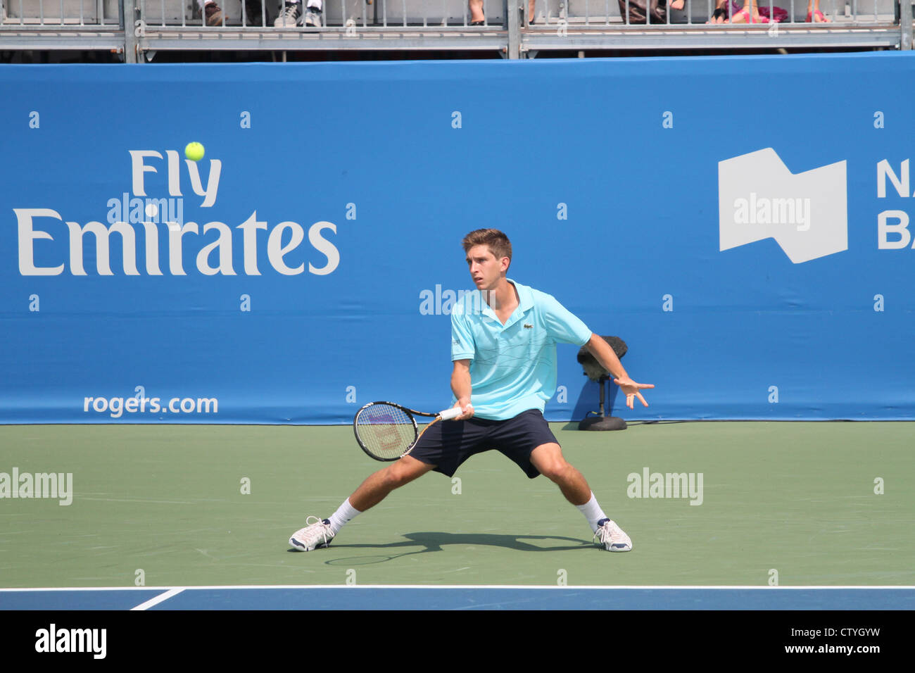 young male tennis player hard court action Stock Photo