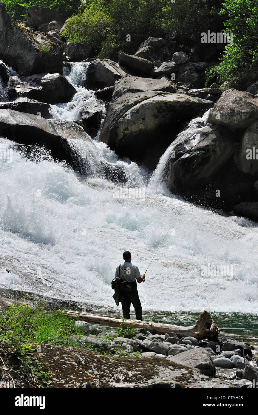 Angler fly fishing at waterfall of the gave de Jéret in the Hautes-Pyrénées near Cauterets, Pyrenees, France Stock Photo