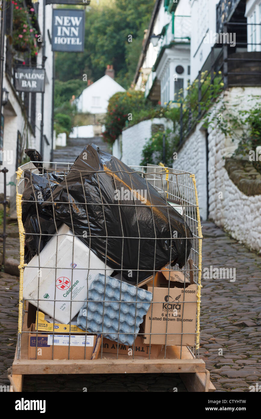 Special sledge trolley for transporting goods down steep narrow traffic-free cobbled street in Clovelly, Devon, England, UK Stock Photo