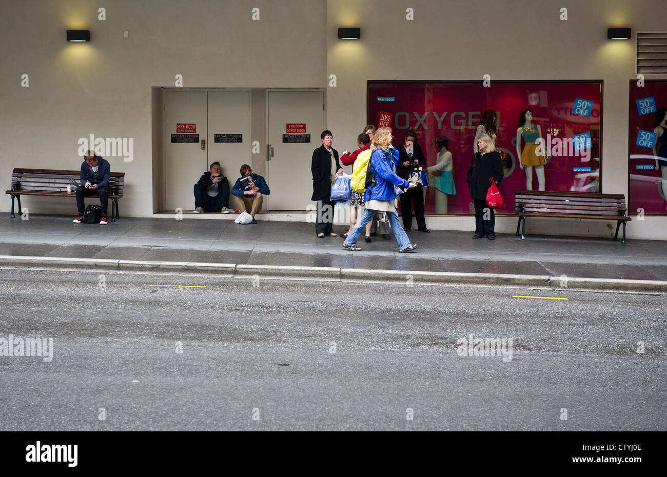 People waiting at a bus stop in Brisbane, Queensland, Australia. Stock Photo