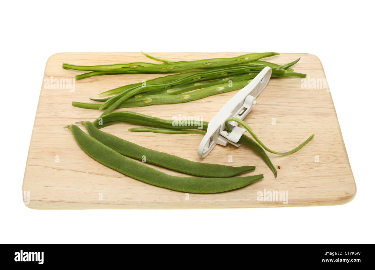 Preparation of runner beans on a wooden board isolated against white Stock Photo