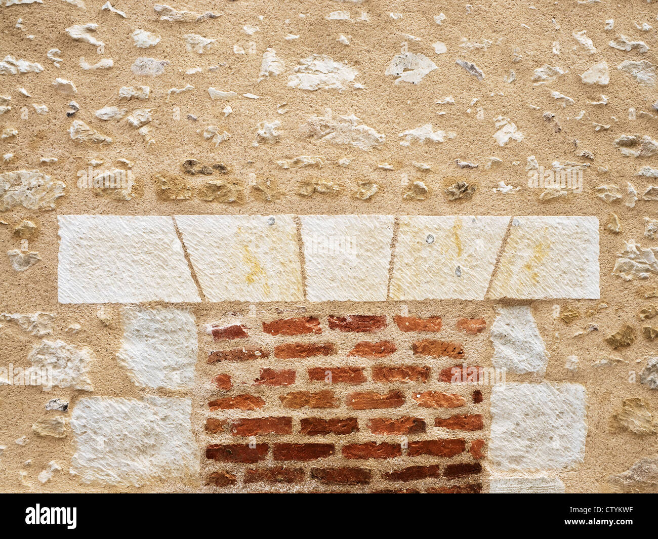Cleaned and re-pointed wall showing brick and stone detail - France. Stock Photo