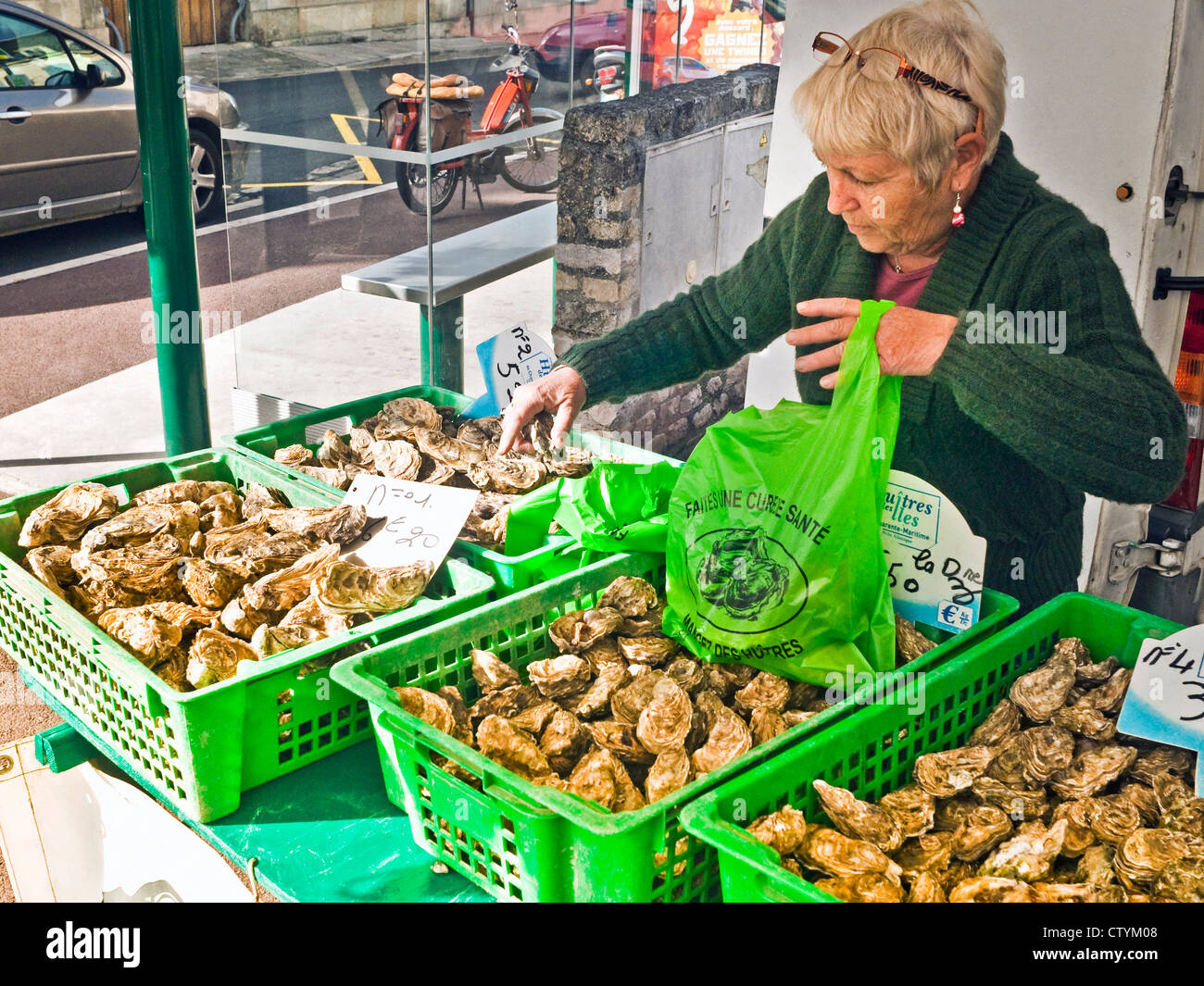 Woman at street market selling oysters France Stock Photo Alamy
