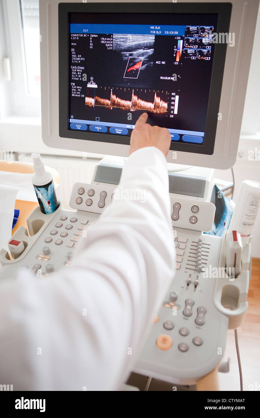 Cardiologist showing EKG on computer monitor Stock Photo