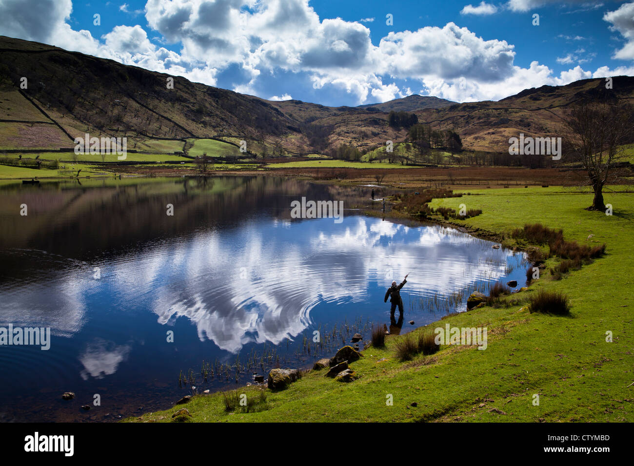 Fly fisherman at Watendlath Tarn, Lake District, England Stock Photo