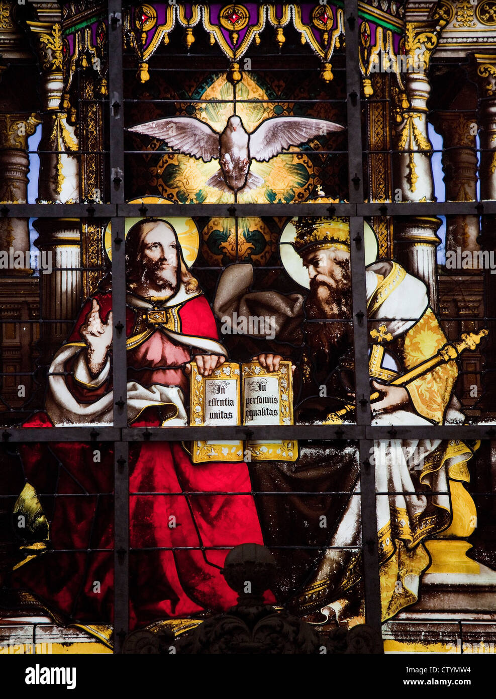 Trinity stained glass window, depicting Father, Son and Holy Spirit. Stock Photo