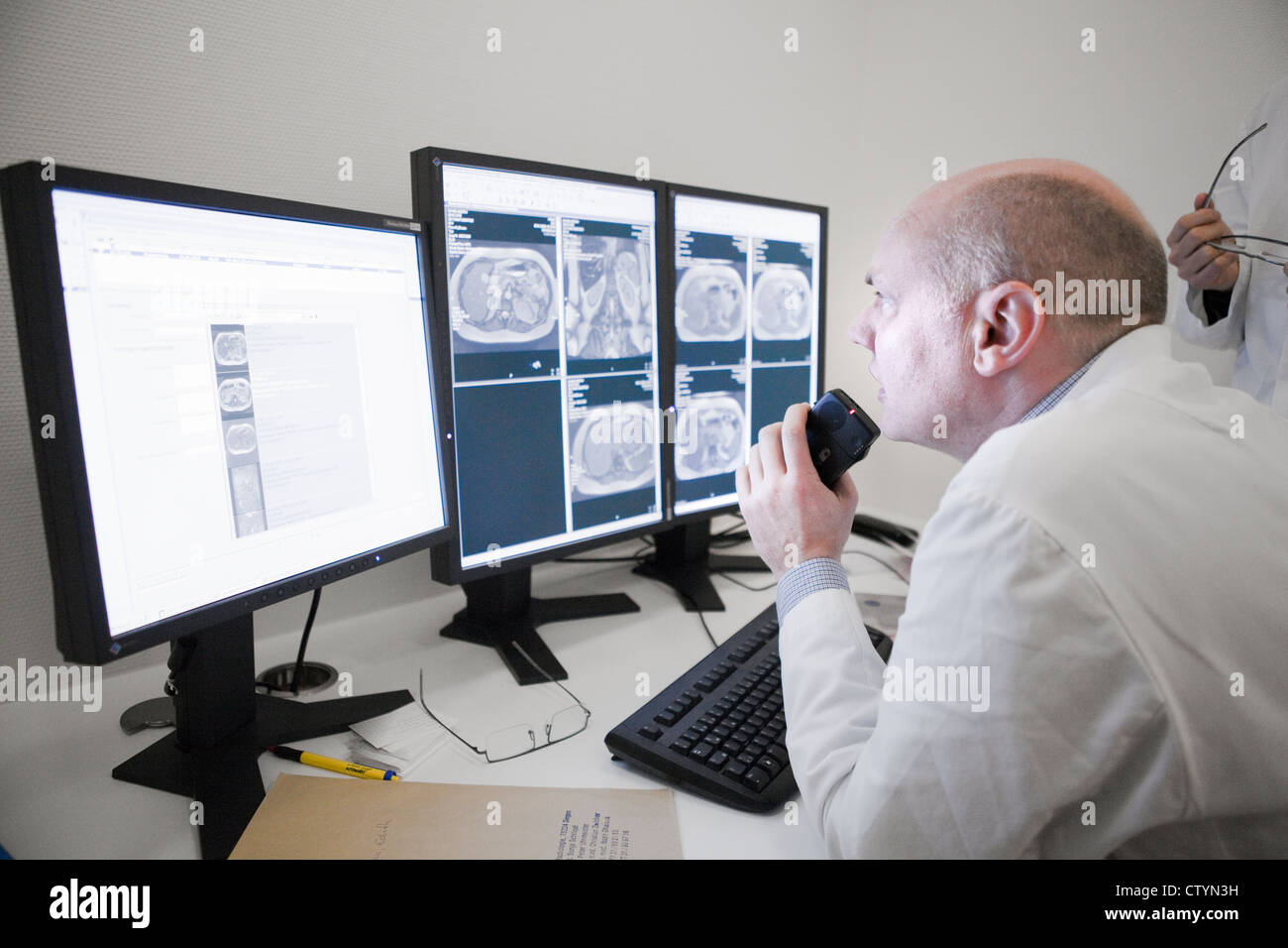 Radiologist examines  MRI scan on monitor Stock Photo