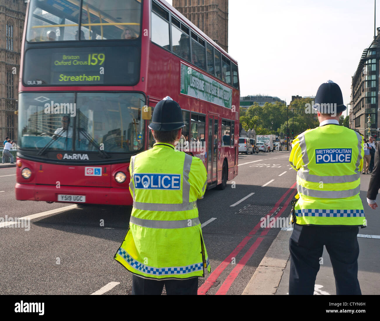 Metropolitan Police officers on duty at Westminster Bridge red route  Houses of Parliament London UK Stock Photo