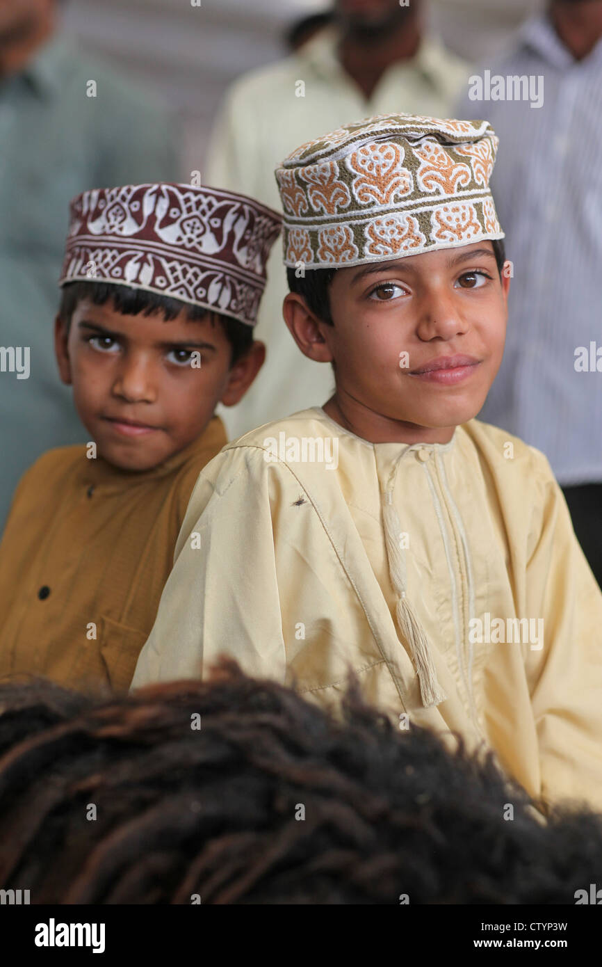 Oman boys with a sheep at the market in Muscat, Oman Stock Photo