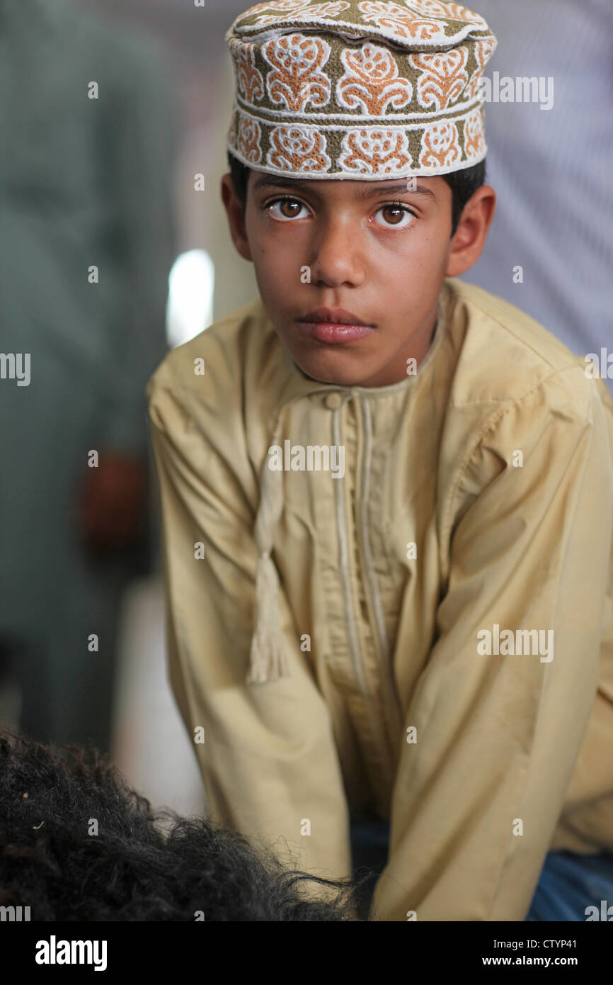 Oman boy, at the market with a sheep Stock Photo