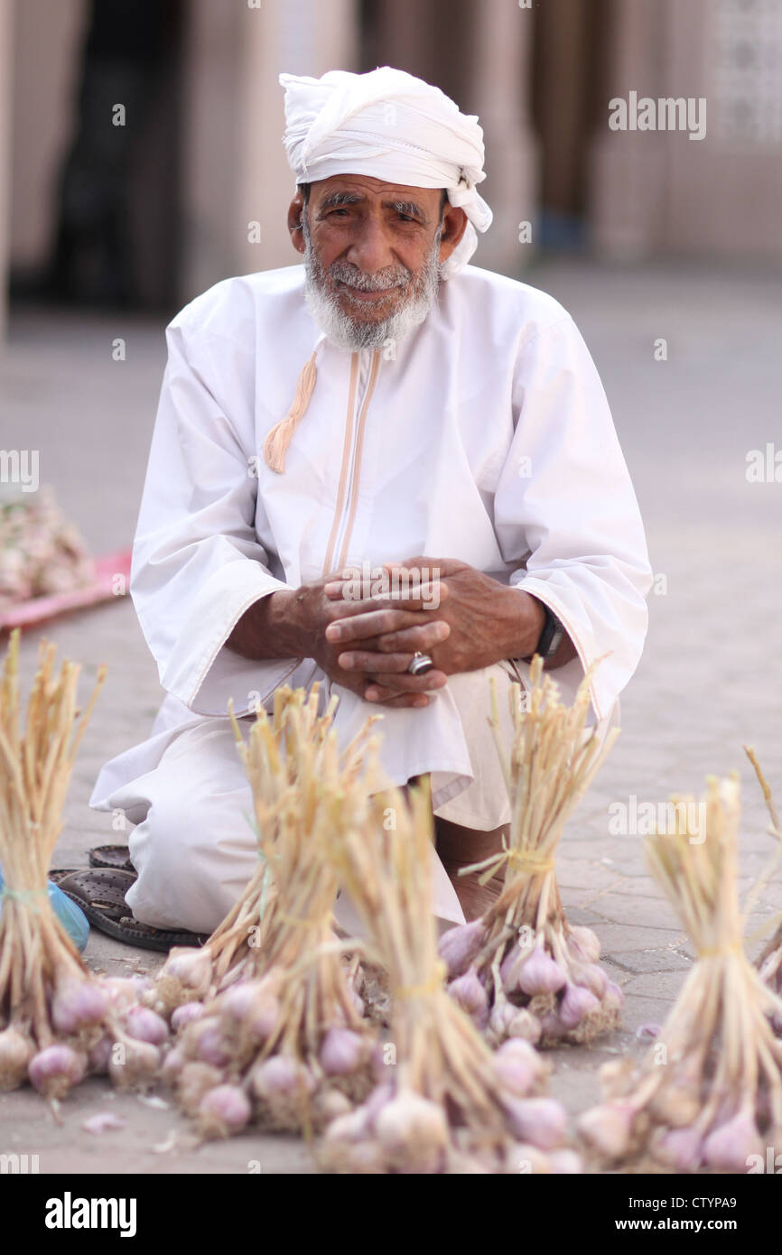 Garlic salesman on the market, Oman, Middle East. Stock Photo