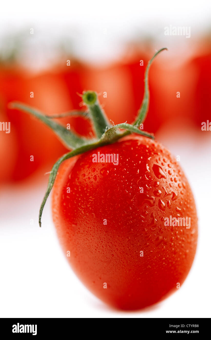 cherry tomato on white, with tomatoes on background, little shadow ...