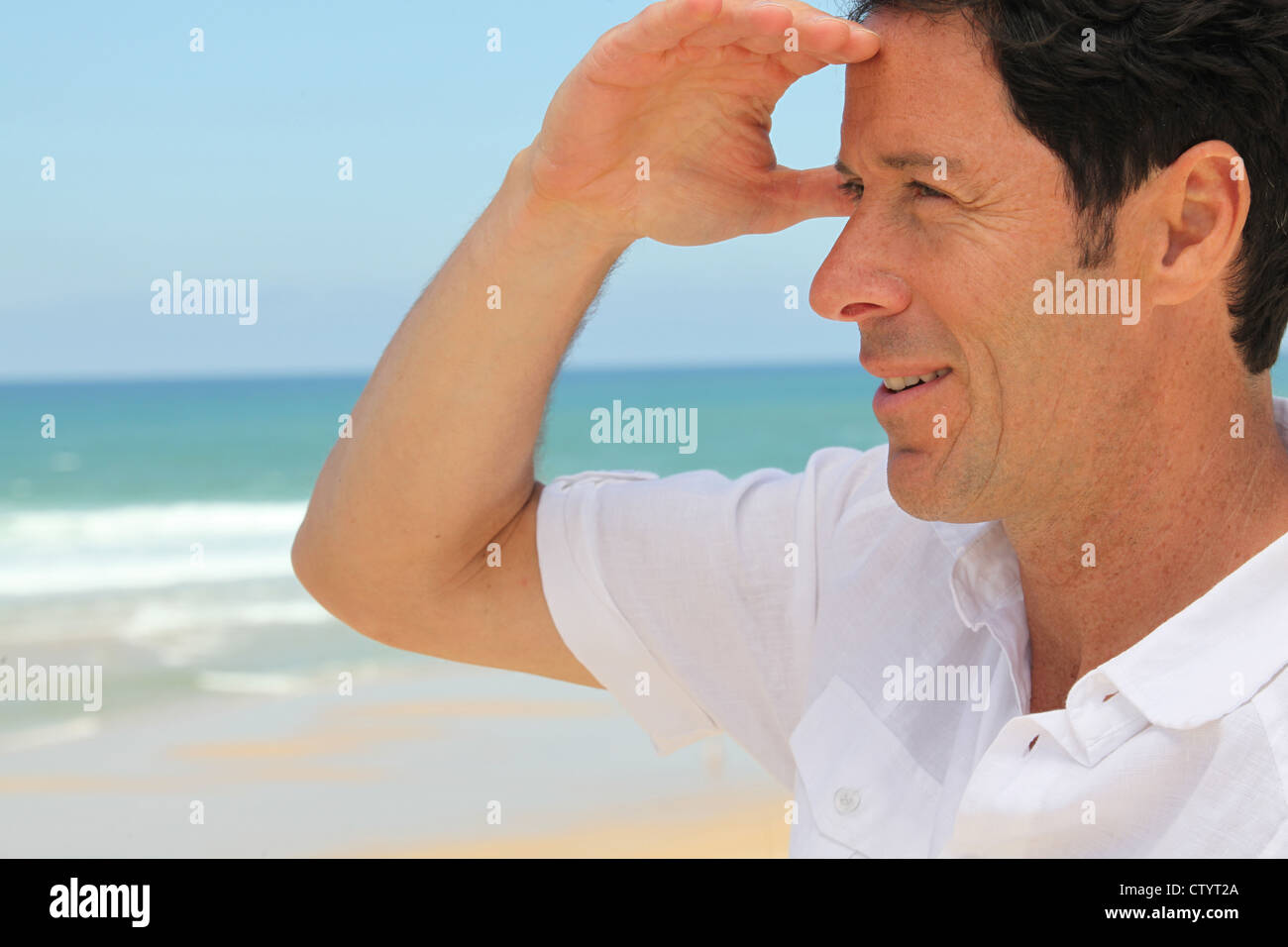 Man looking out to sea Stock Photo - Alamy