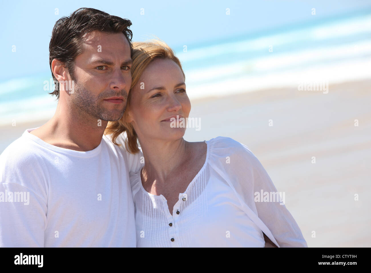 Couple relaxing on the beach Stock Photo - Alamy