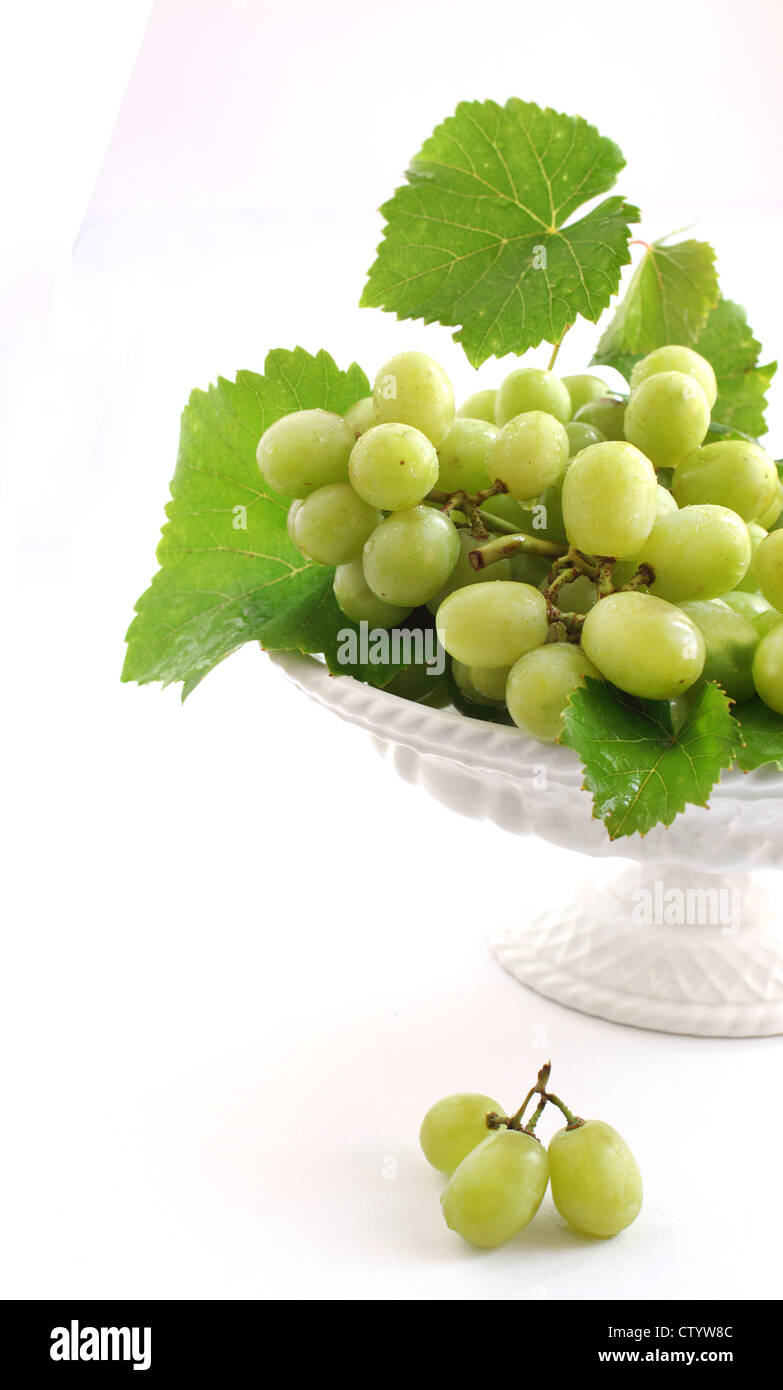 Green grape in vase isolated on white Stock Photo