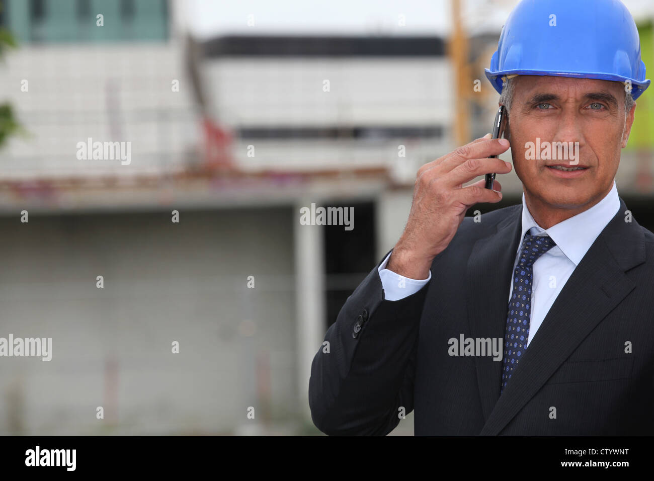 handsome architect making a call in construction site Stock Photo - Alamy
