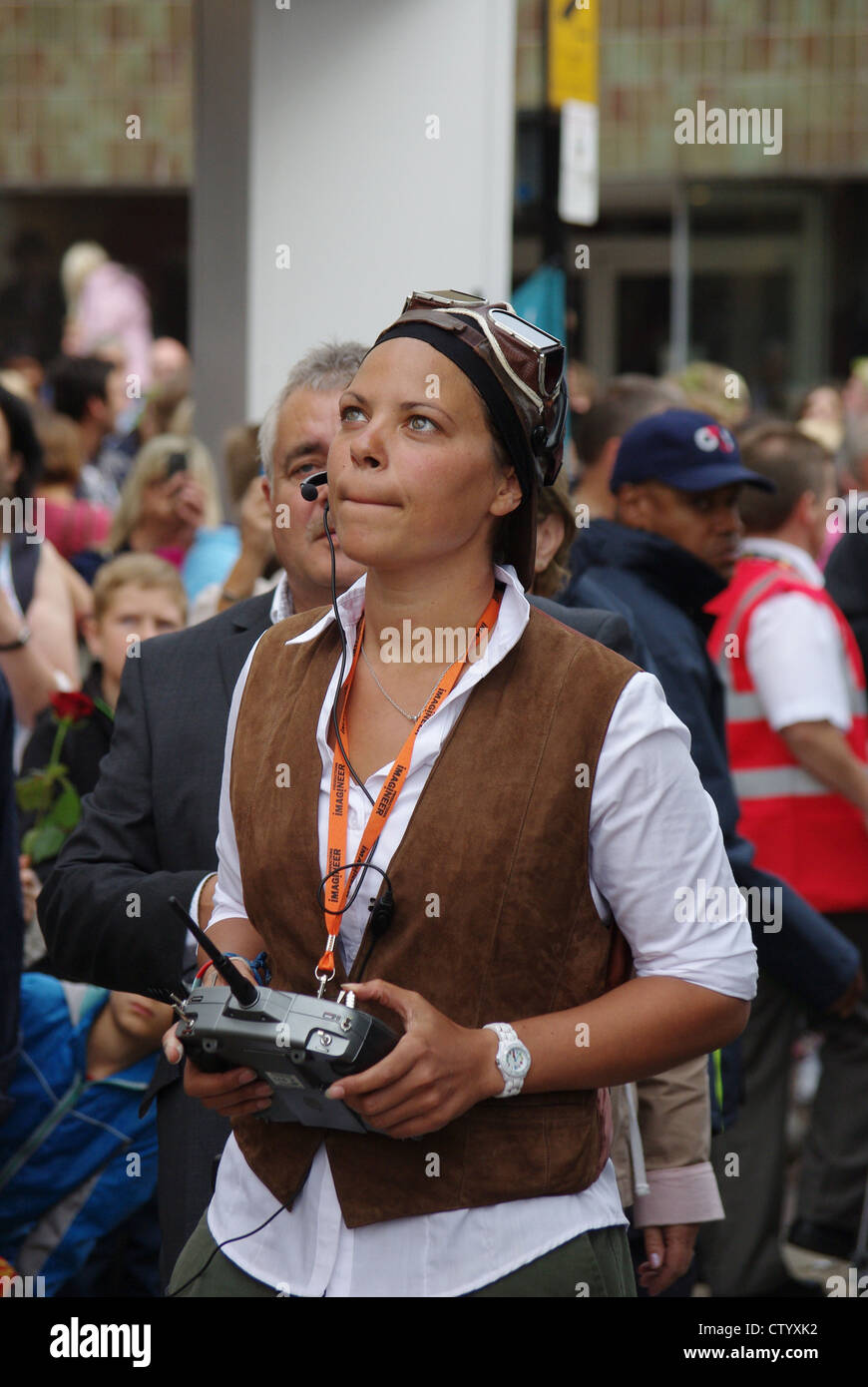 Woman operating a radio control unit for the Godiva puppet, a Cultural Olympiad event in Northampton Stock Photo