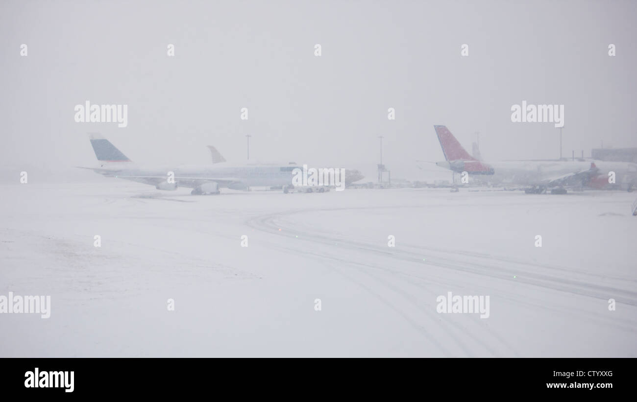 Airplanes on snowy runway Stock Photo