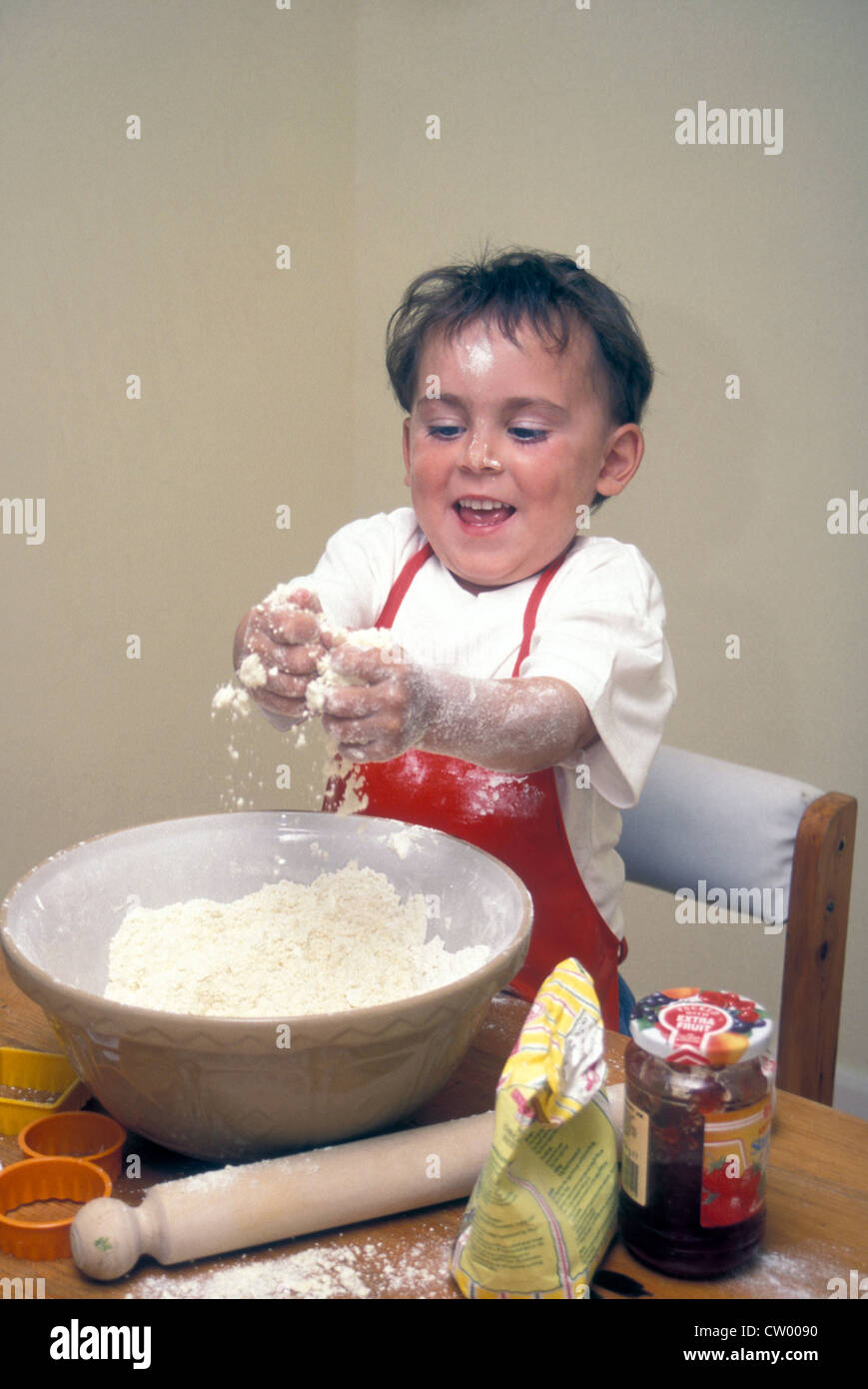 little boy making jam tarts Stock Photo Alamy