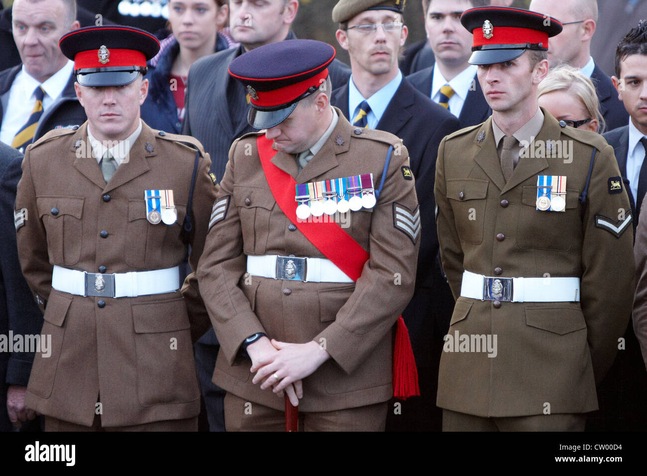 Friends, family & colleagues of L/Cpl Peter Eustace react during a ...