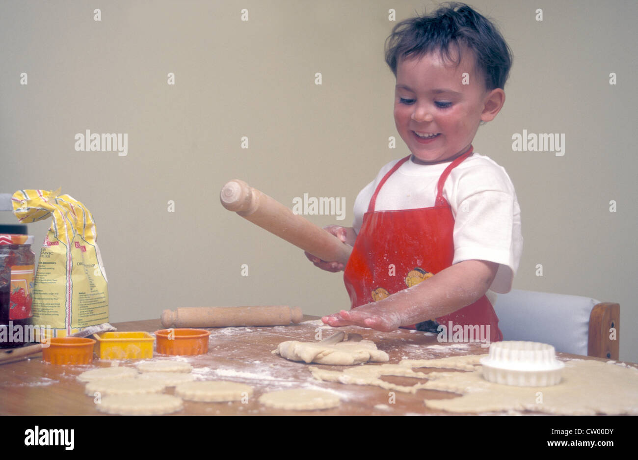 little boy making jam tarts Stock Photo Alamy