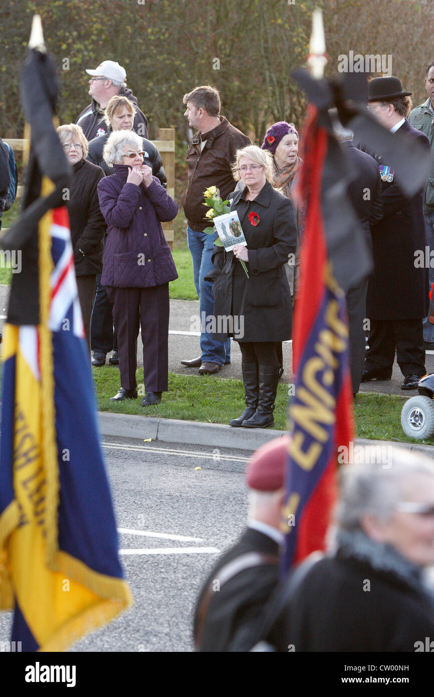 A standard bearer is seen during the repatriation ceremony for four