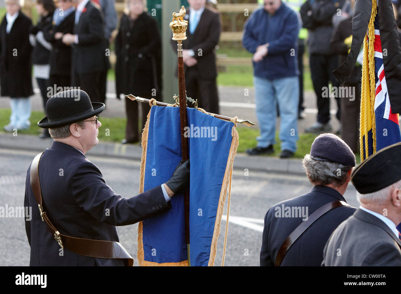 A standard bearer is seen during the repatriation ceremony for four