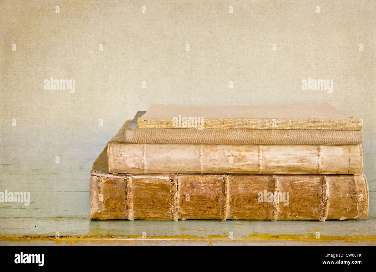 Ancient old books on a wooden table with textured editing Stock Photo