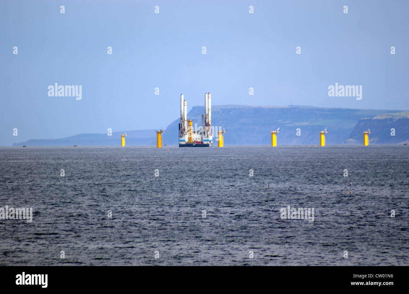 SHIP ERECTING AND INSTALLING WIND TURBINES OFFSHORE FARM IN THE SEA AT REDCAR Stock Photo