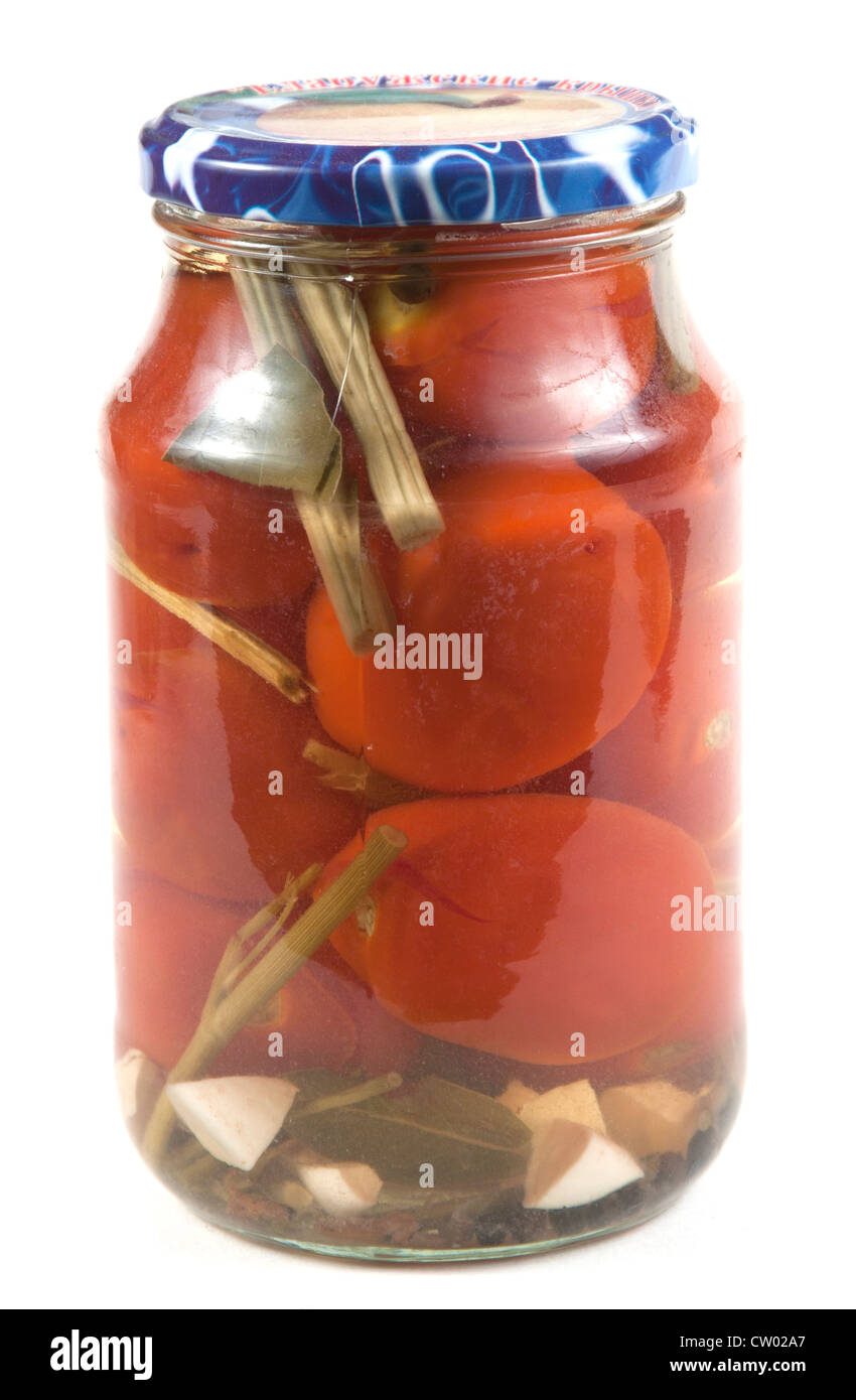 Preserved tomatoes in a jar, isolated on white Stock Photo