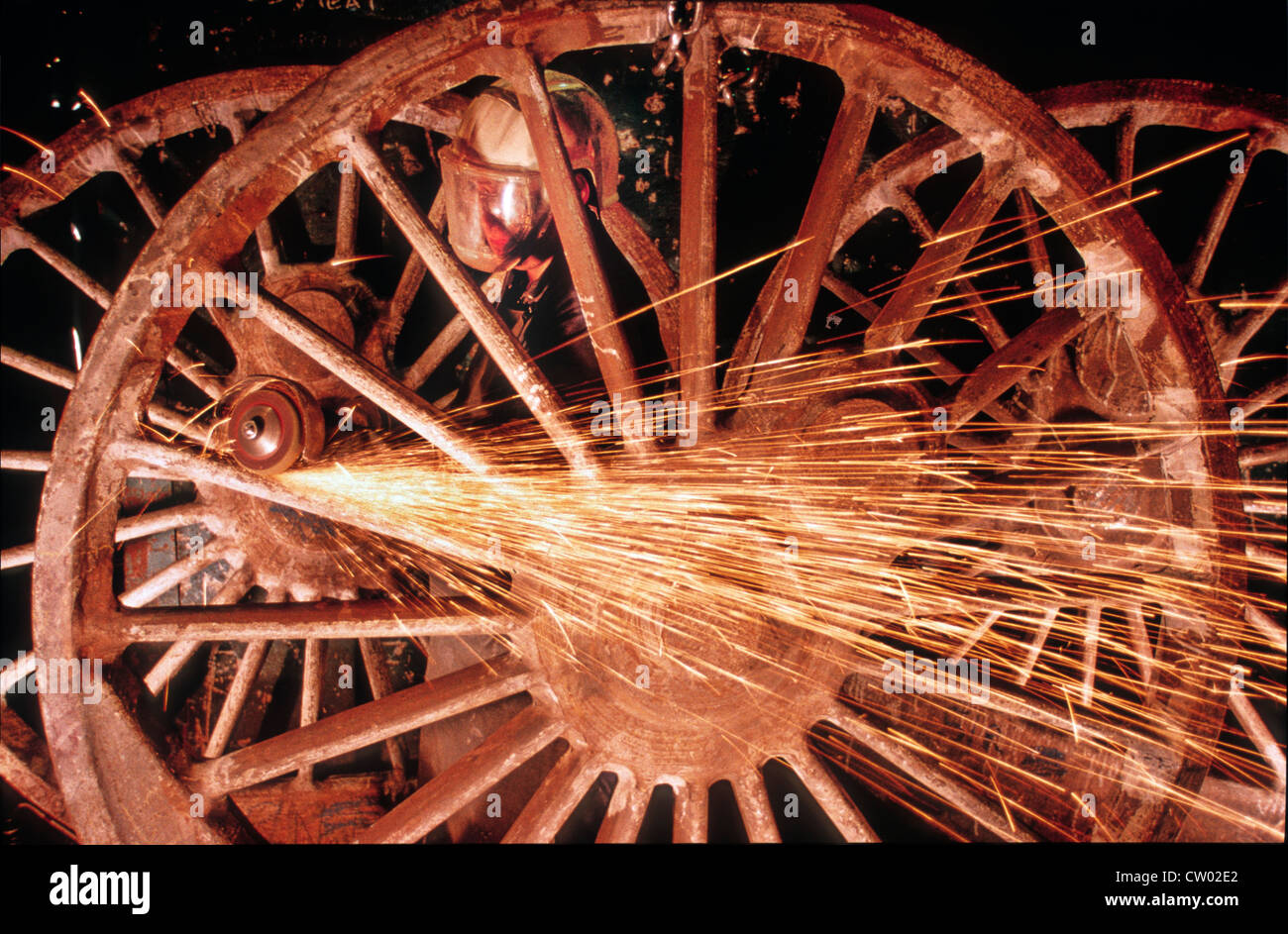 A fettler works on the 6ft 8 inch Driving wheels of LNER Class A1 Steam Locomotive 60163 Tornado at a foundry in Burton on Trent , Staffordshire Stock Photo