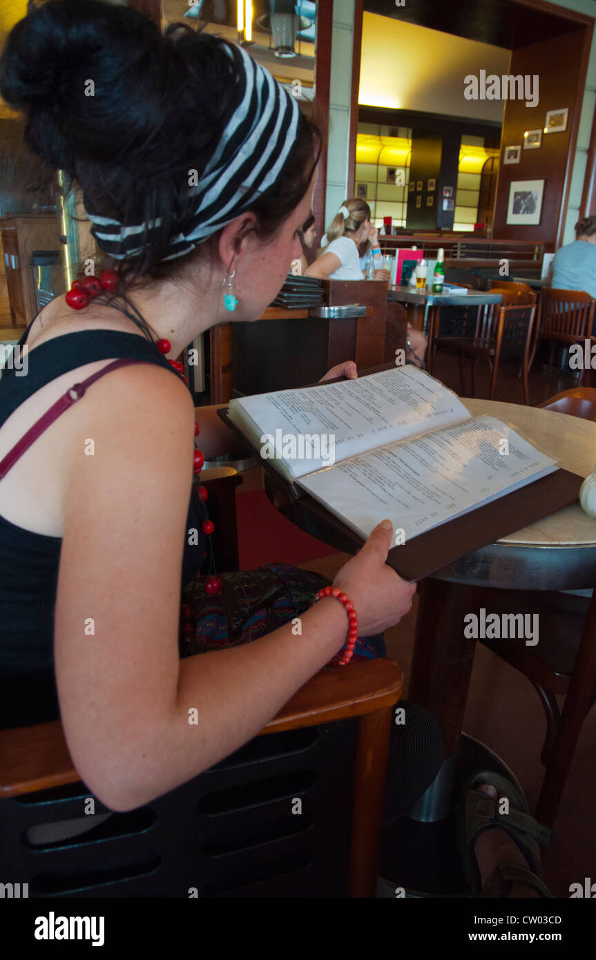 Female in her late 20s studying the menu Cafe Slavia central Prague Czech Republic Europe Stock Photo