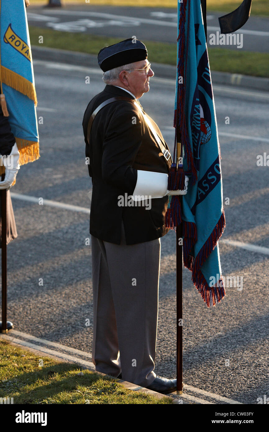 A standard bearer is seen during the repatriation ceremony for