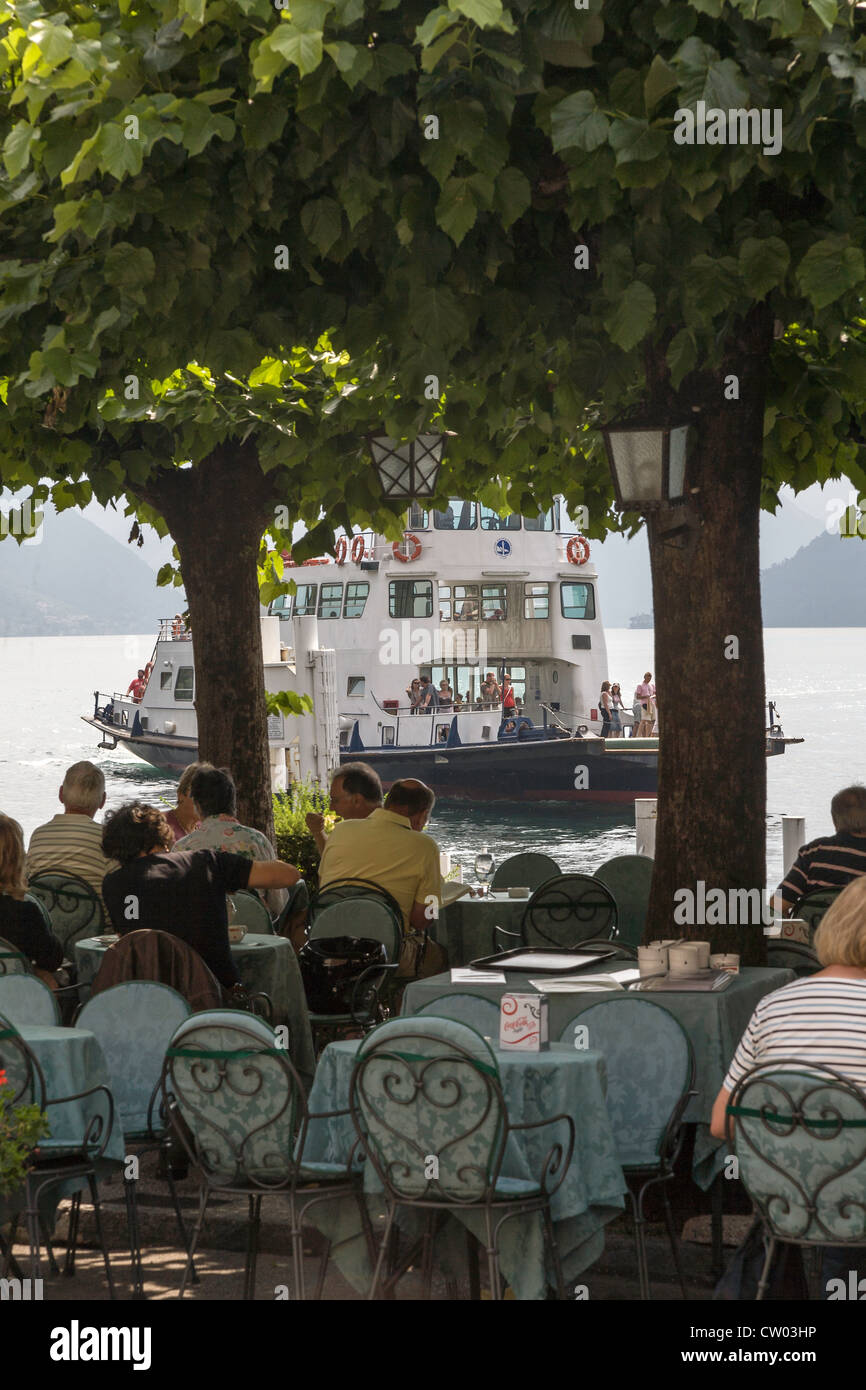 Lakeside cafe/restaurant under trees in Bellagio on Lake Como in Italy Stock Photo