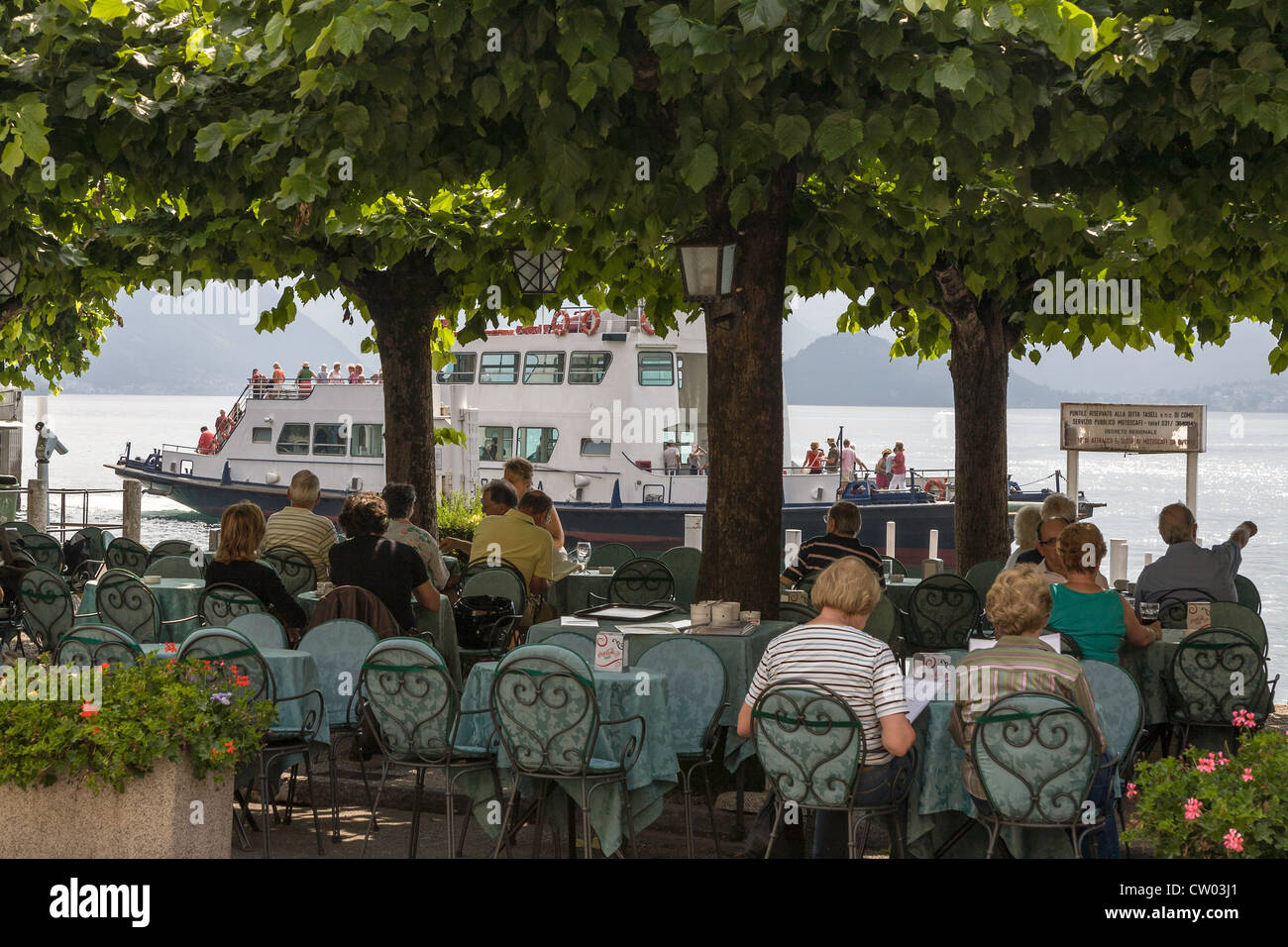 Lakeside cafe/restaurant under trees in Bellagio on Lake Como in Italy Stock Photo