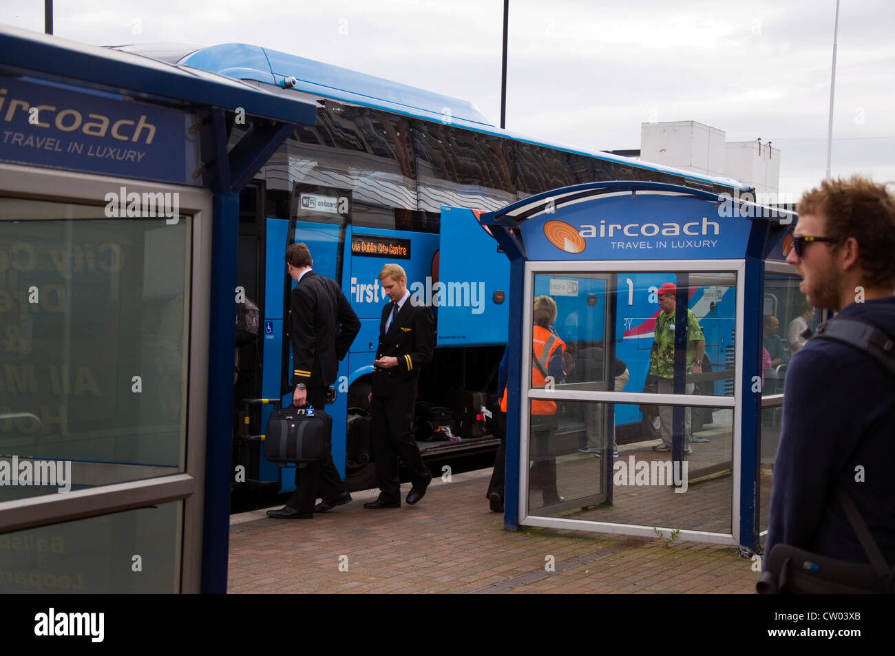 Passengers and aircrew board an Aircoach bus into city centre Stock Photo