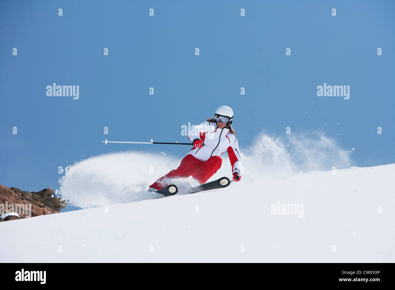 Skier coasting on snowy slope Stock Photo