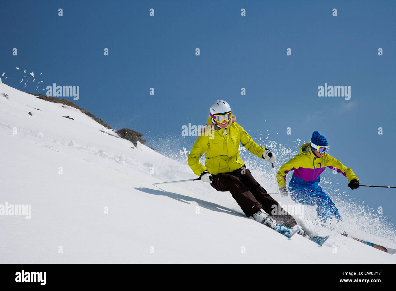 Skiers coasting on snowy slope Stock Photo