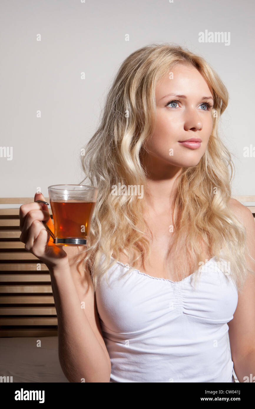Woman drinking tea in bed Stock Photo Alamy