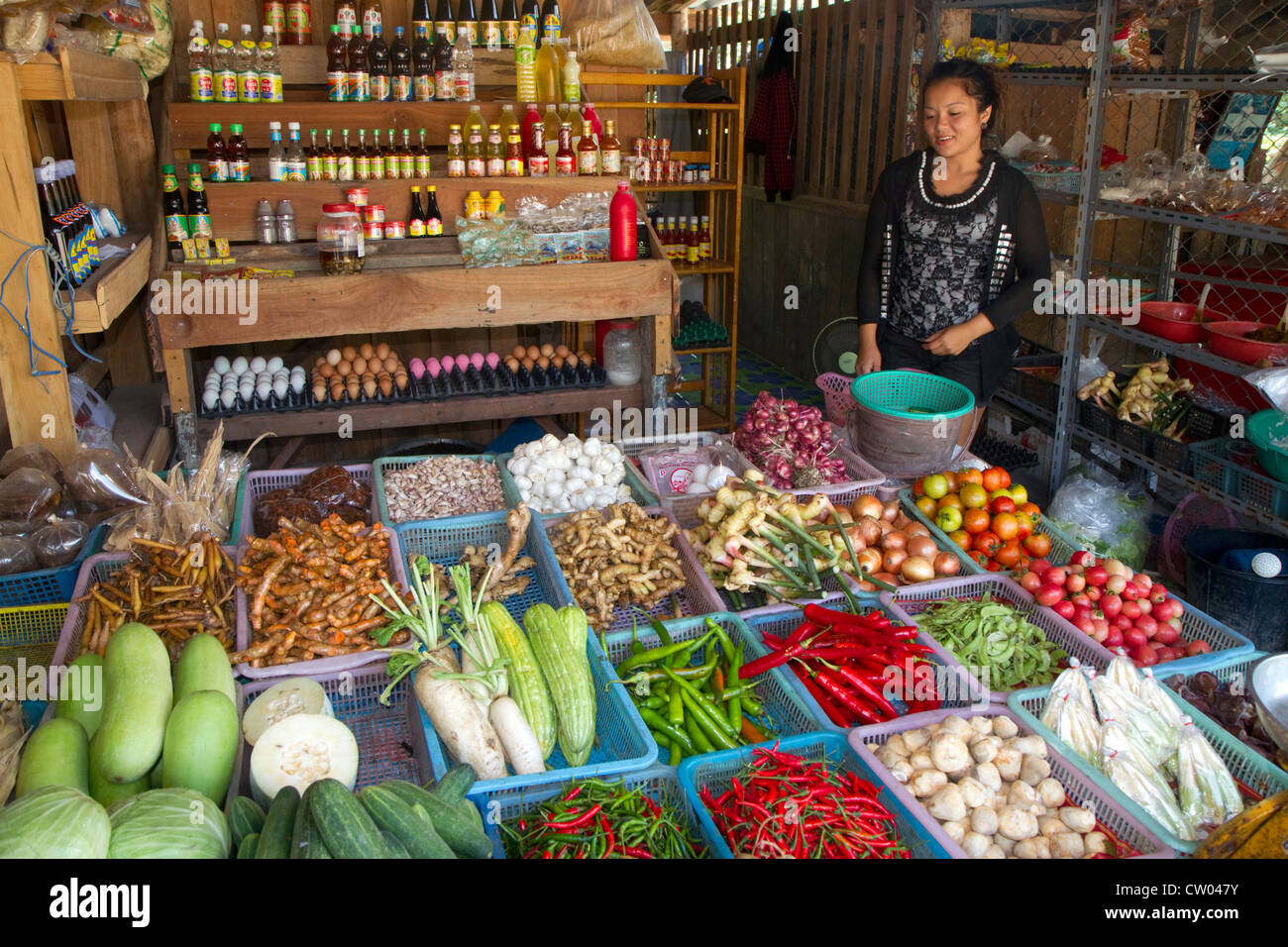 Woman selling fresh vegetables and eggs at an open air market on the island of Ko Samui, Thailand. Stock Photo