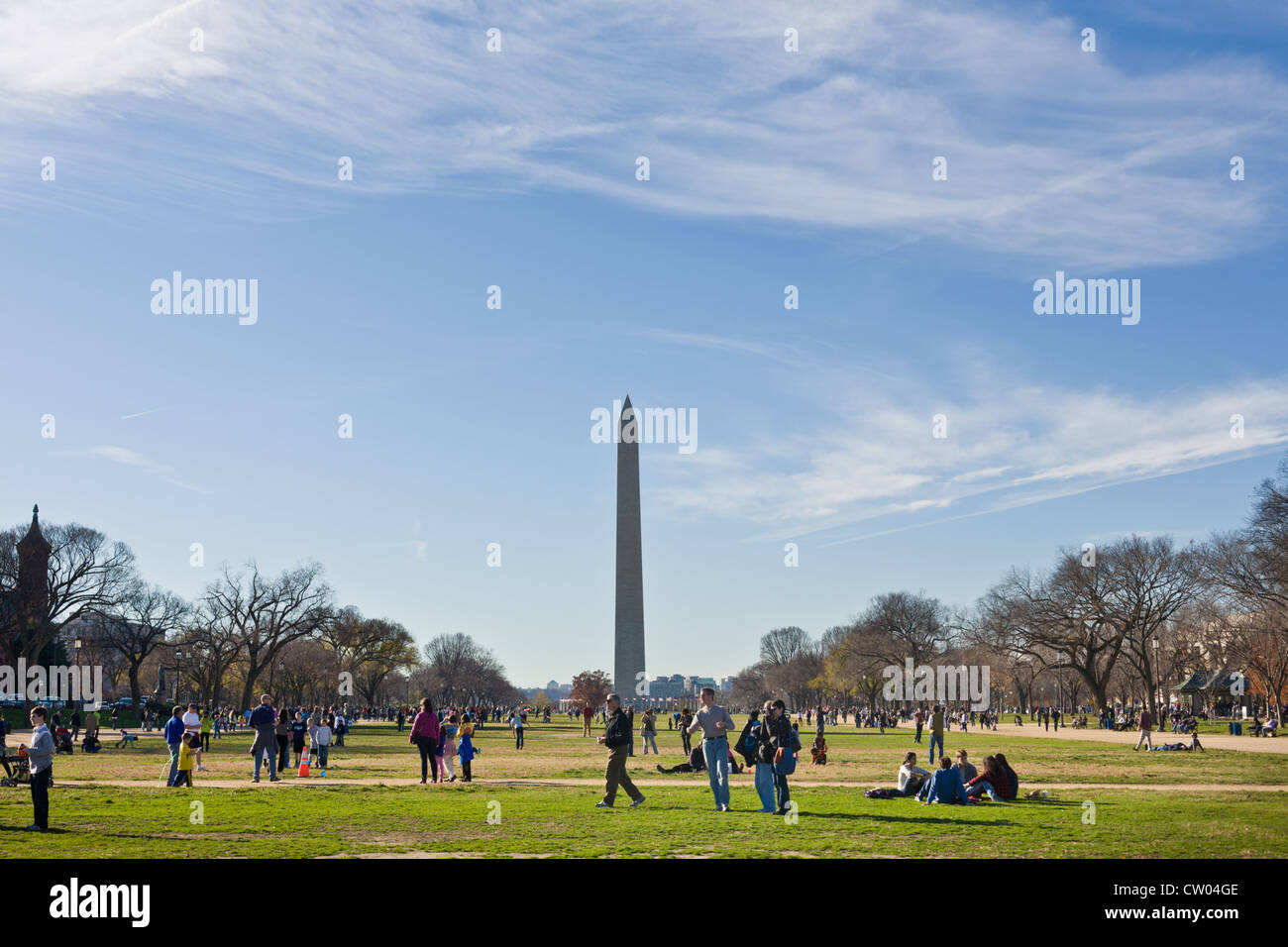 Crowds enjoying a mild winter day on the National Mall, Washington DC, Monument behind. Stock Photo