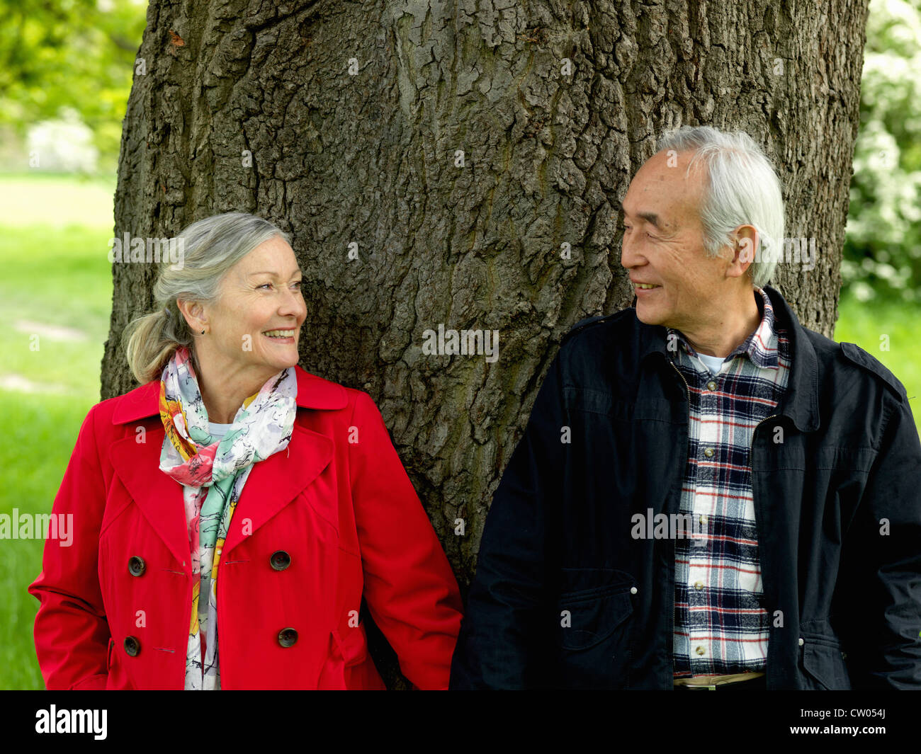 Older couple walking together in park Stock Photo