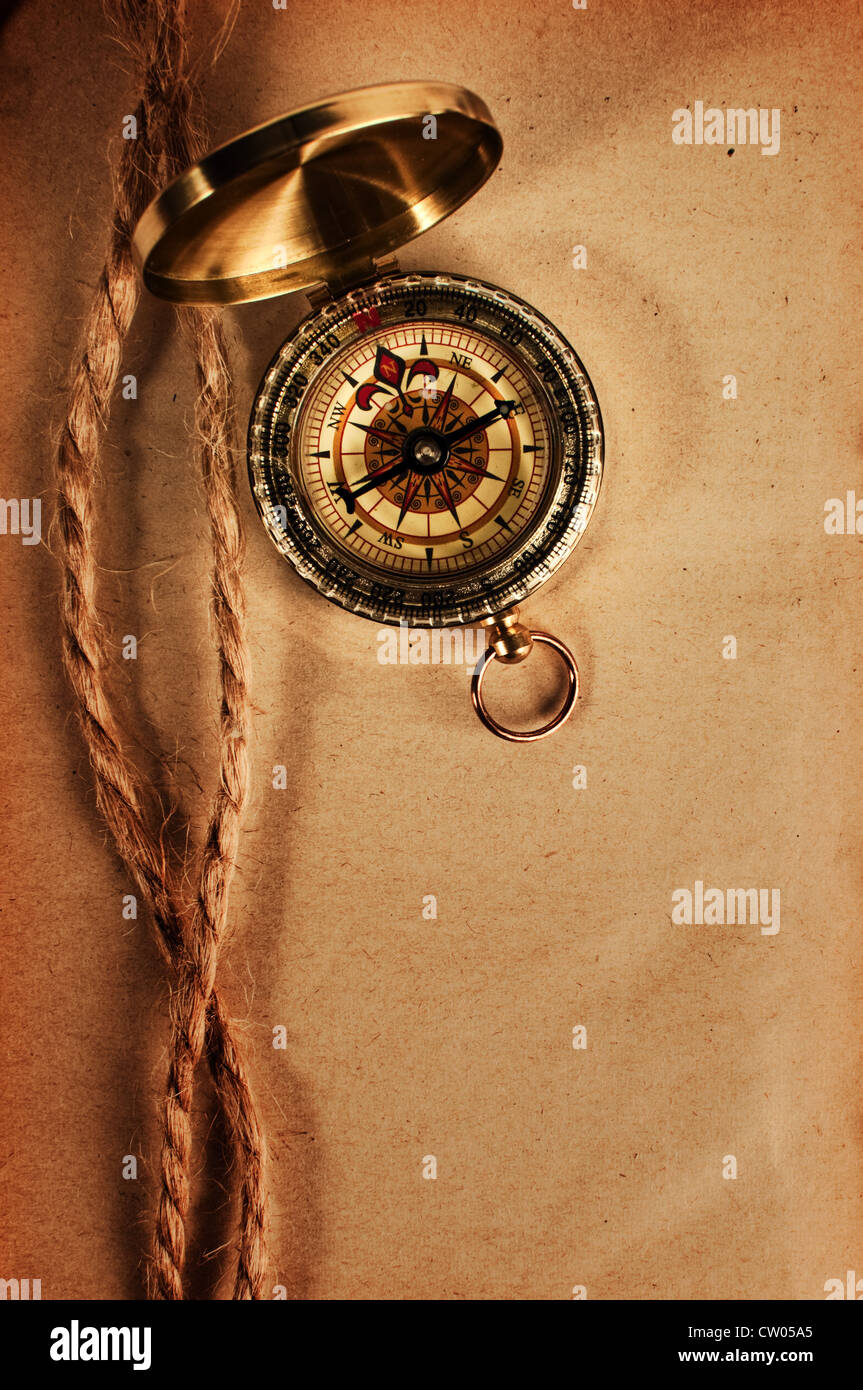 Vintage compass top shot over a grungy yellow paper Stock Photo