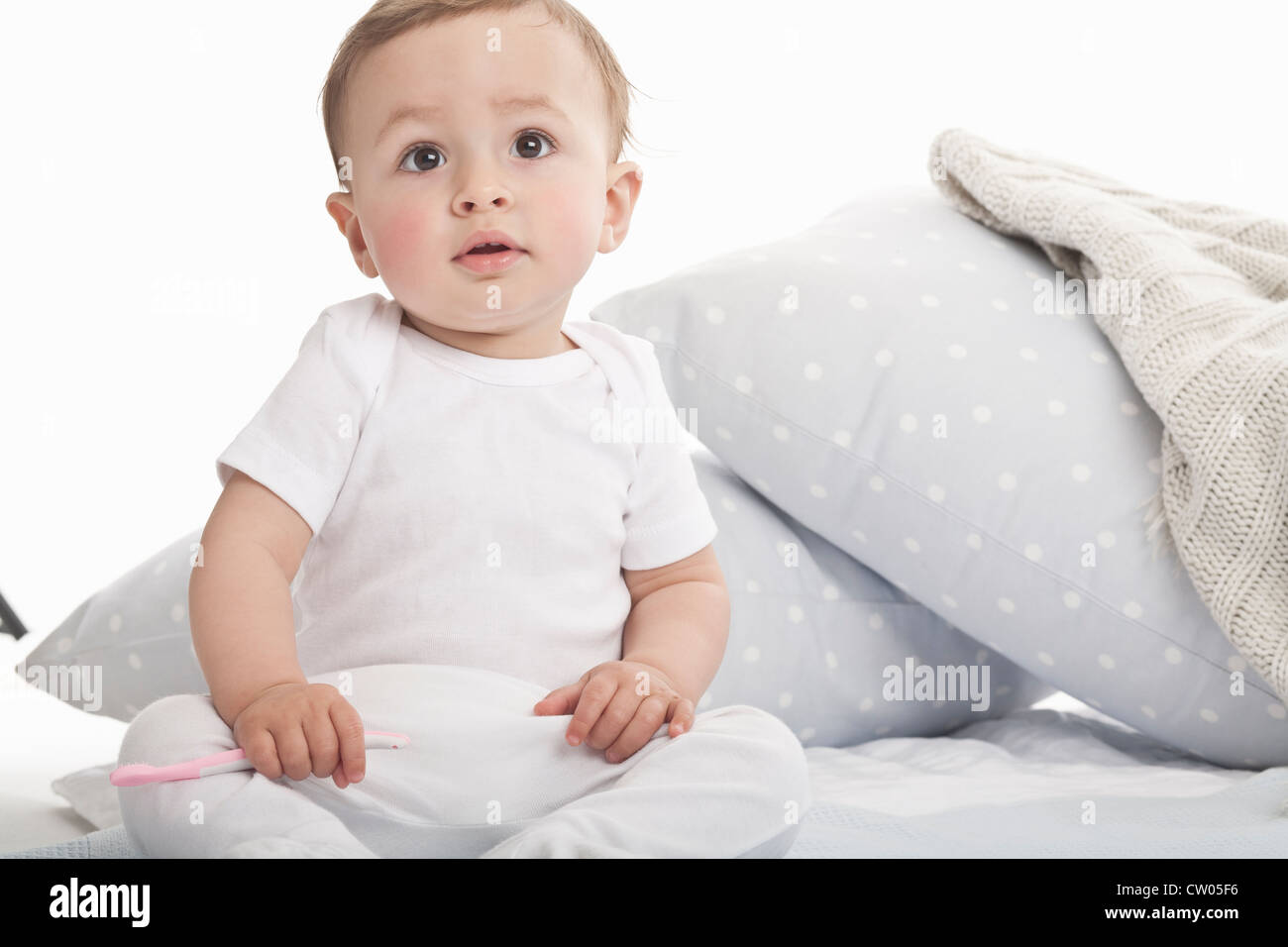 Baby sitting on couch Stock Photo Alamy