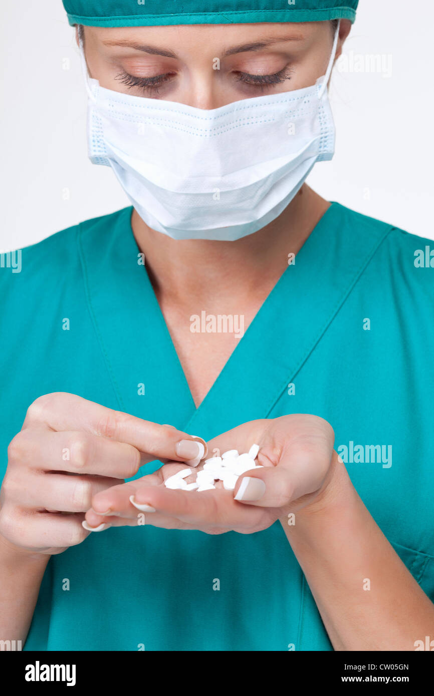 Close up of surgeon counting pills Stock Photo