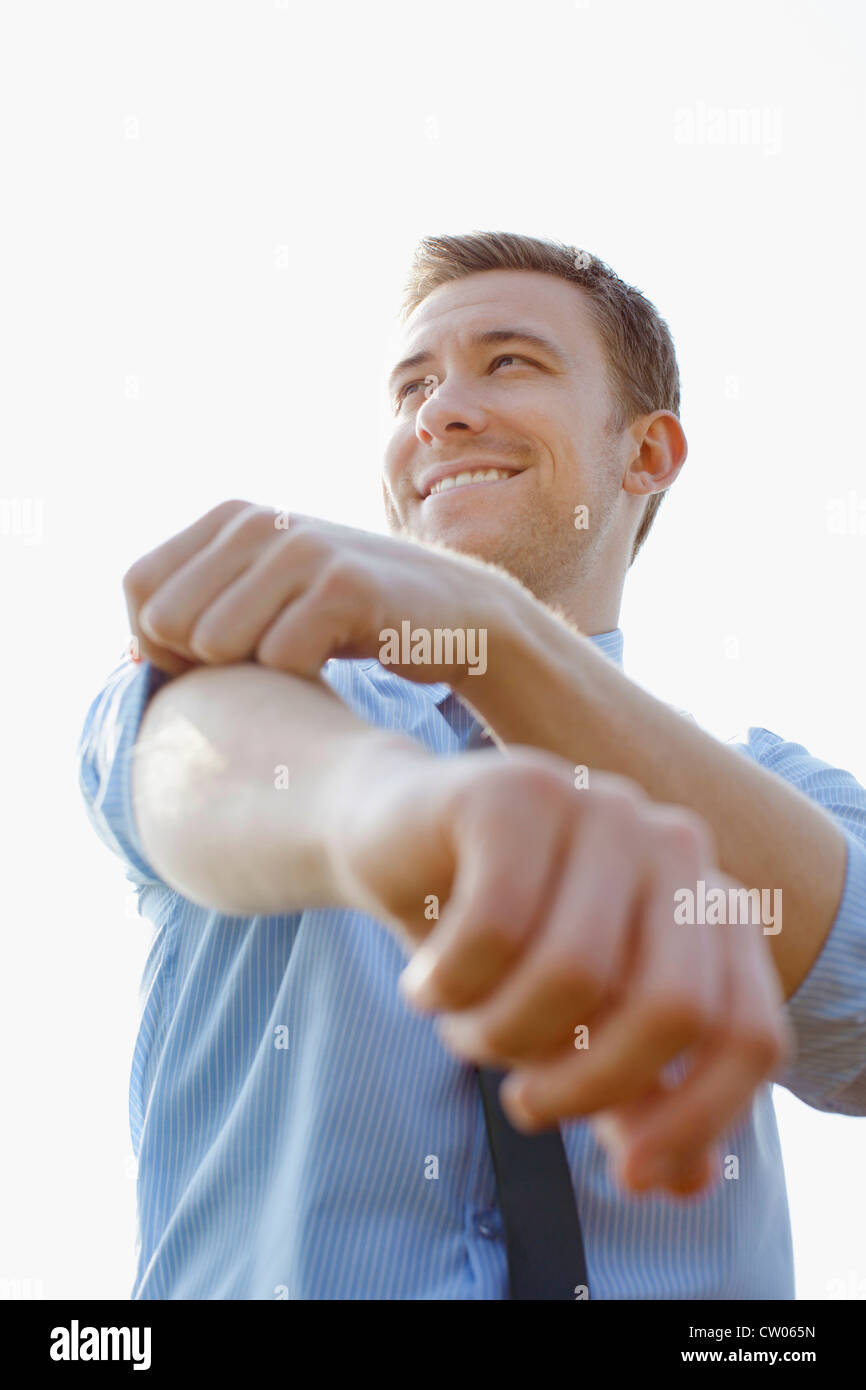 Businessman rolling up sleeves Stock Photo