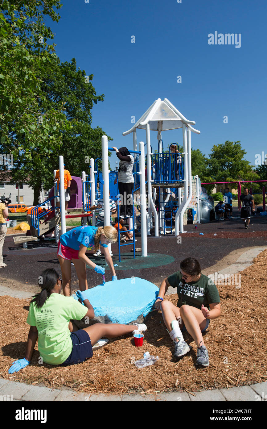Volunteers paint playground equipment in Detroit's Romanowski Park