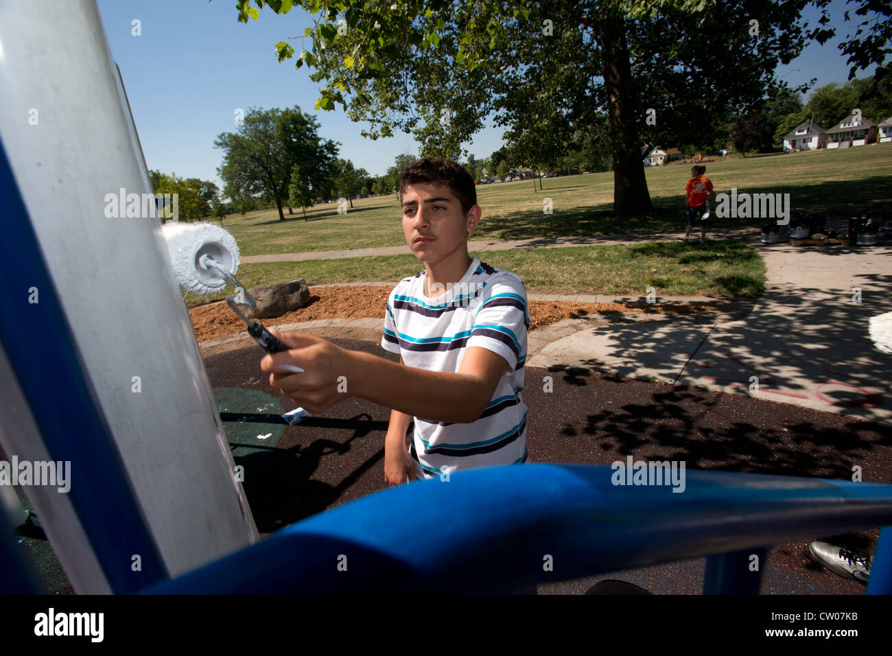 Volunteers paint playground equipment in Detroit's Romanowski Park Stock Photo Alamy
