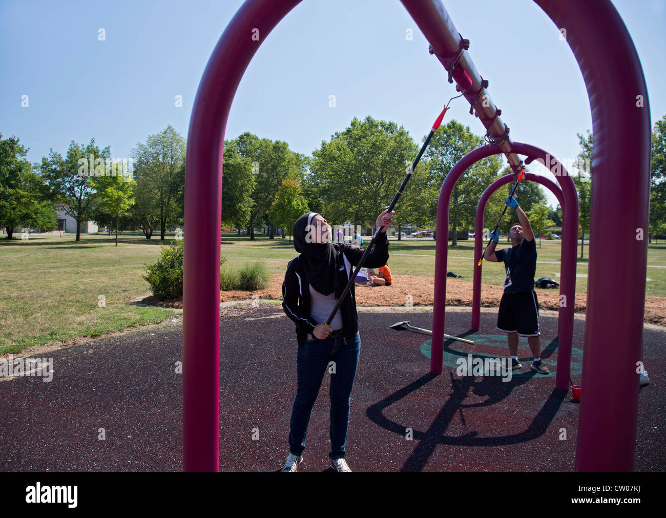 Volunteers paint playground equipment in Detroit's Romanowski Park