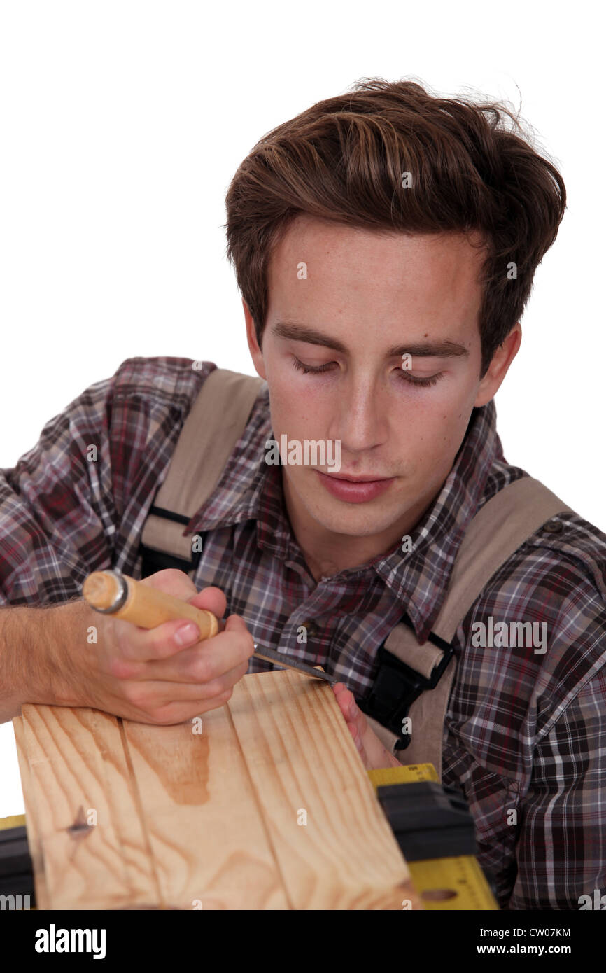 Carpenter using a chisel to sculpt wood Stock Photo